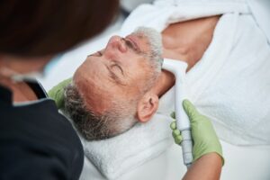 Senior citizen enjoying facial skin treatment at spa